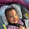 baby, child, smiling, car_seat, seatbelt, sunlight, face, hand, clothing, pink, blanket, infant, cute, portrait, indoor, safety, happy, seat, child_safety, car