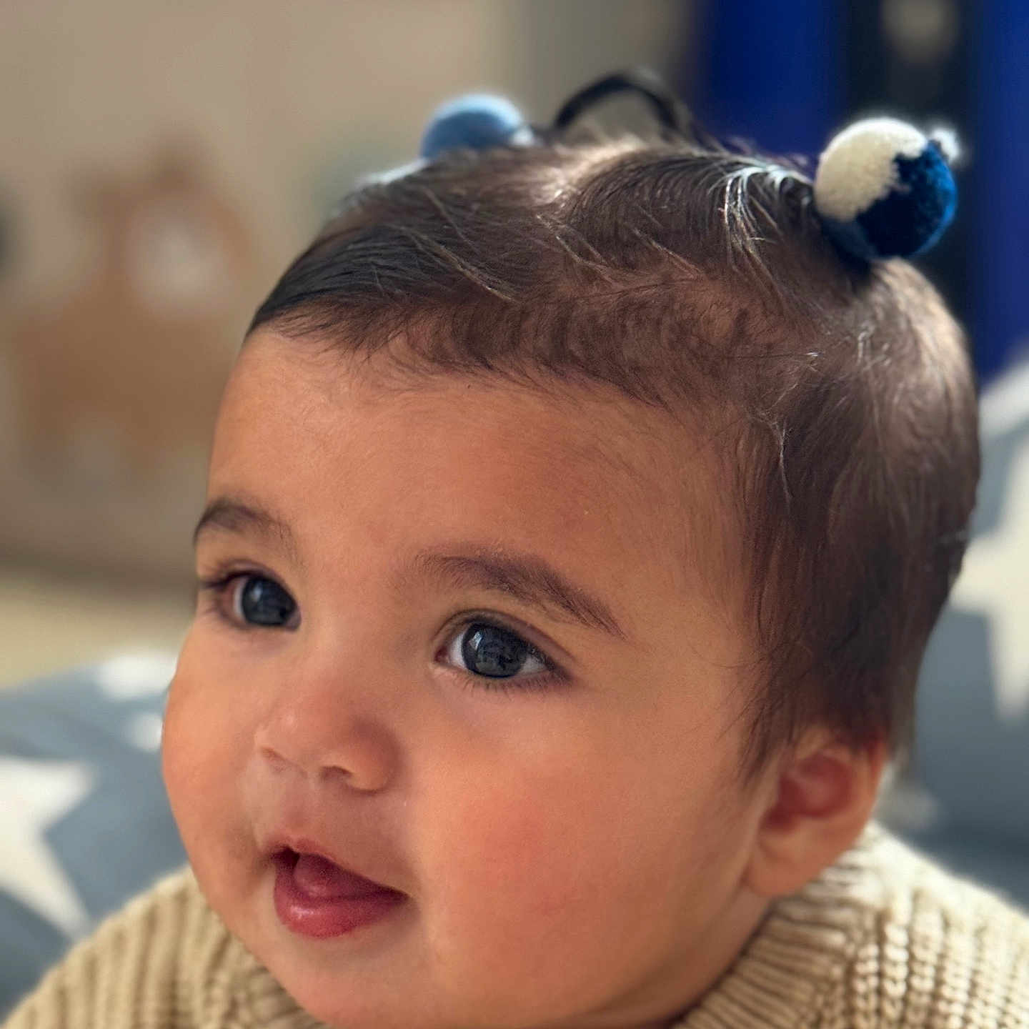 Vivienne joined the competition — help win amazing prizes! baby, background_blur, child, closeup, cozy, cute, expression, eyes, face, hair_buns, head, indoor, knitted_sweater, person, portrait, skin, smiling, soft_light, star_pattern, young_child