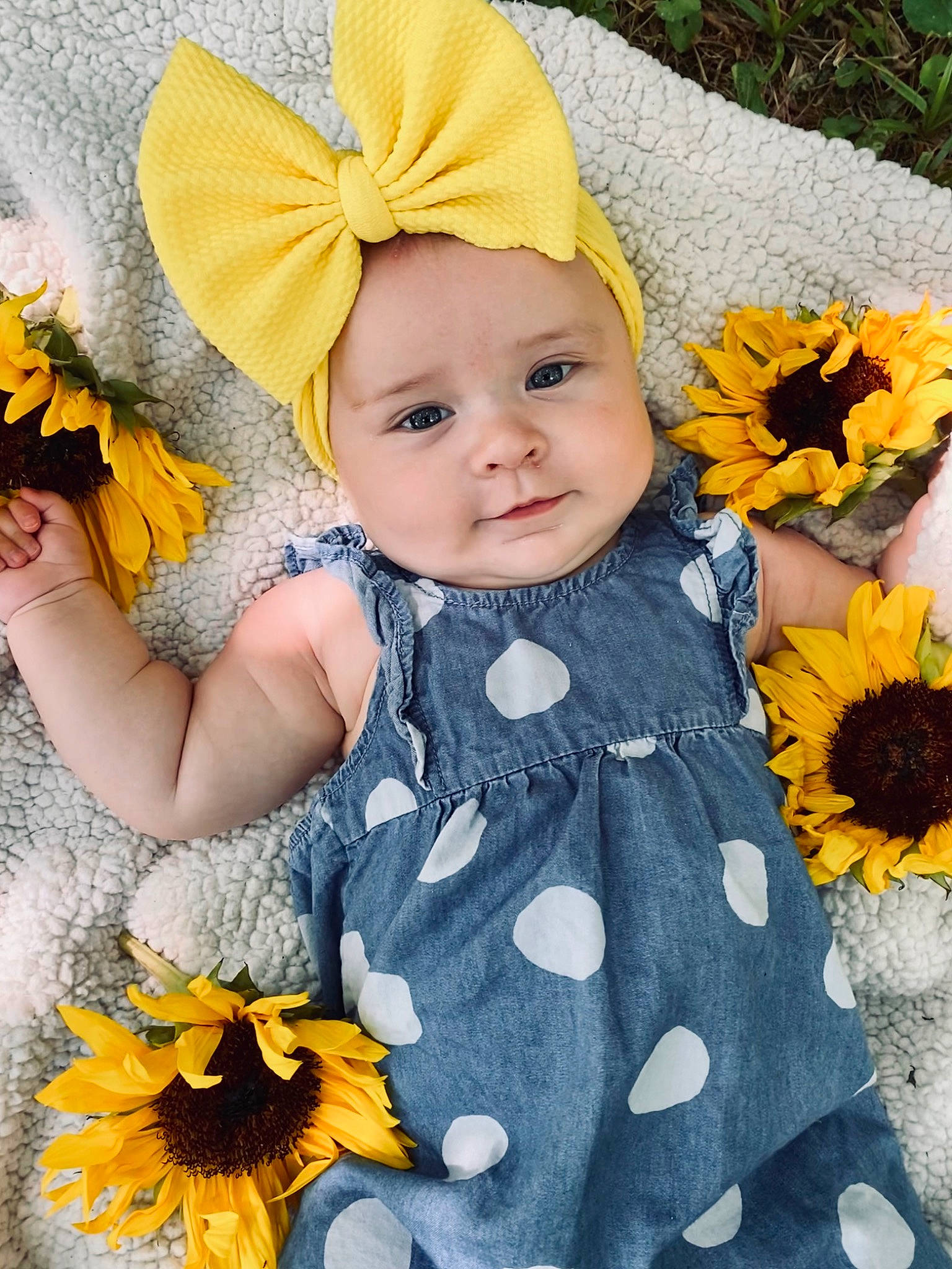 Elsie joined the competition — help win amazing prizes! baby_toddler_clothing, blue, dress, eye, flower, green, happy, headwear, iris, leaf, orange, organ, outerwear, people_in_nature, person, petal, photograph, plant, skin, textile