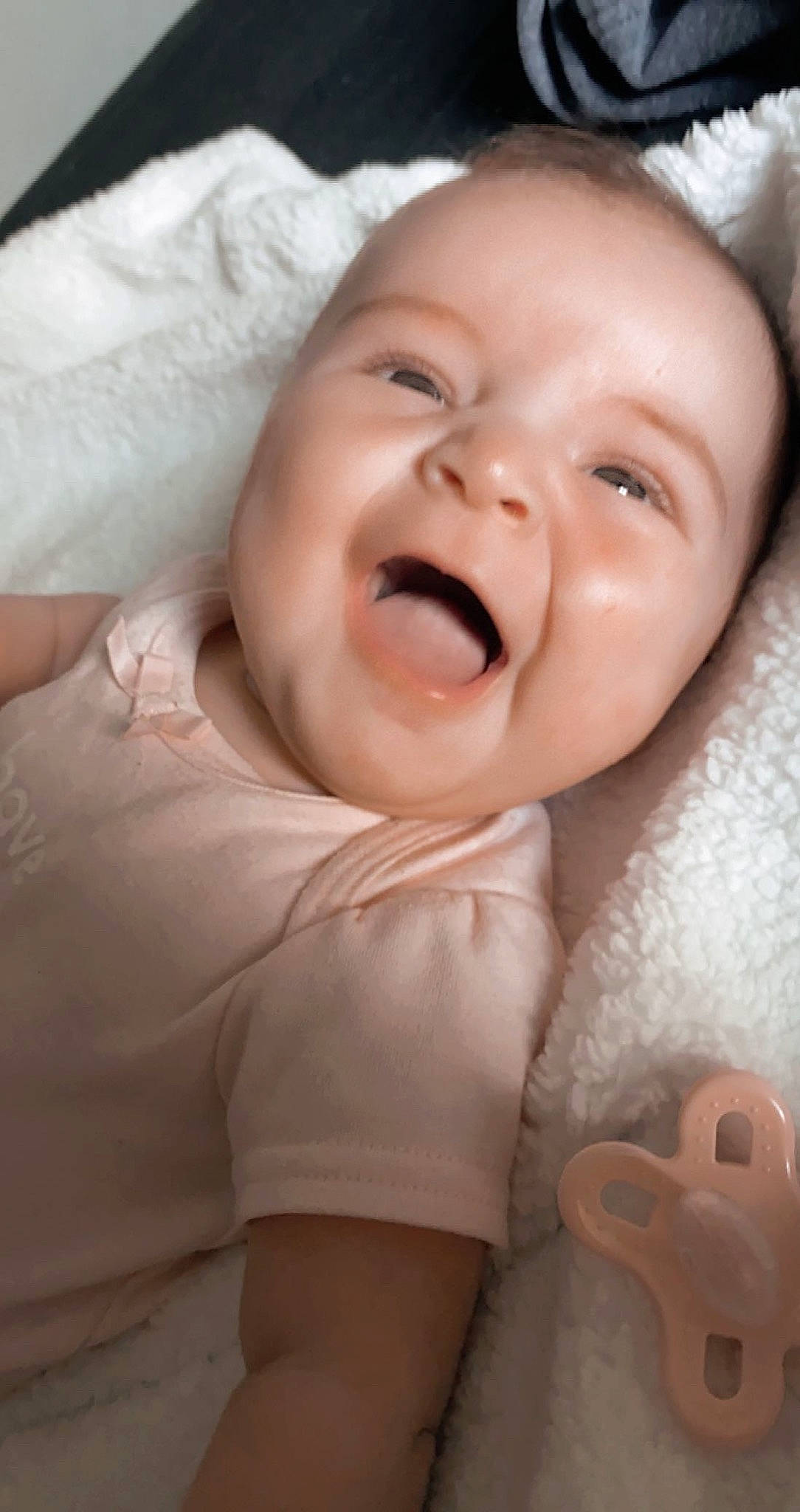 Lillie is registered to the contest to win money with this photo: baby, baby_toddler_clothing, cheek, comfort, eye, eyebrow, flash_photography, gesture, happy, head, human_body, iris, lip, mouth, nose, person, pink, skin, sleeve, smile