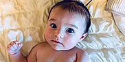 Sakari joined the competition — help win amazing prizes! baby, infant, child, diaper, bare_chest, lying_down, bed, blanket, curly_hair, spikes, expression, face, skin, indoors, soft_lighting, cute, portrait, looking_at_camera, young, person