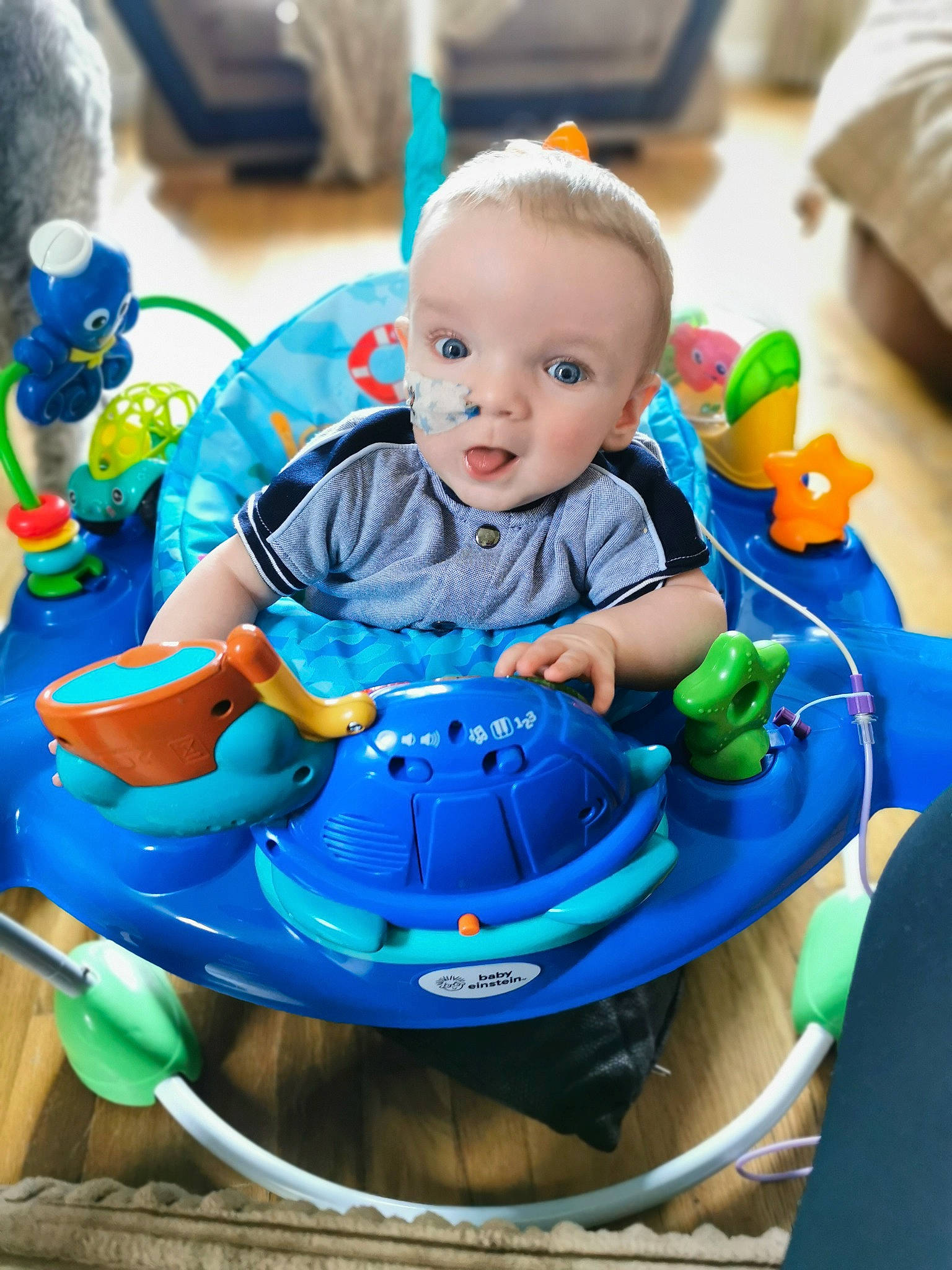 Blaze is registered to the contest to win money with this photo: baby, baby_playing_with_toys, baby_products, baby_toddler_clothing, blue, chair, child, electric_blue, event, facial_expression, fun, happy, leisure, person, play, product, recreation, sitting, smile, toddler