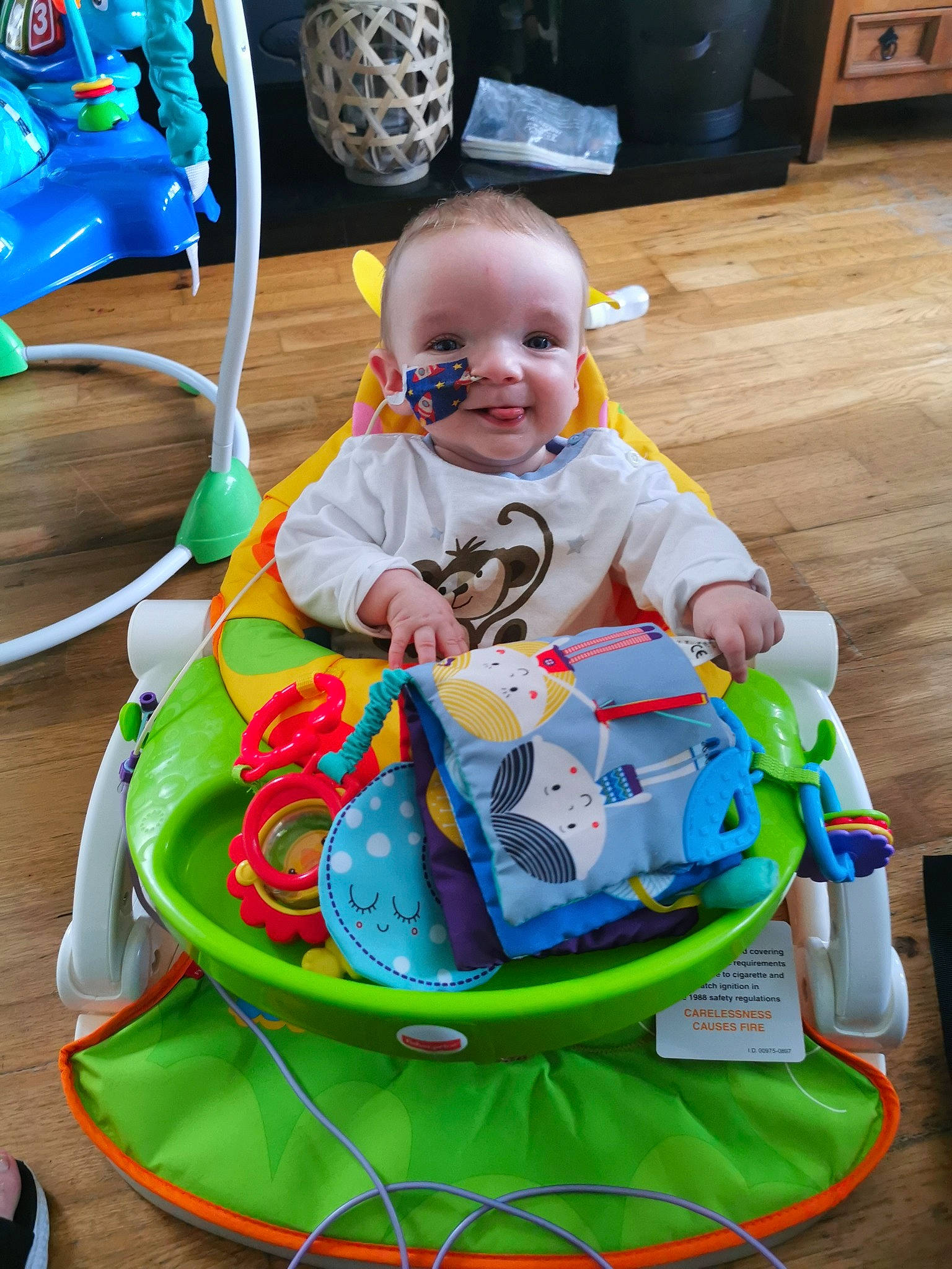 Blaze is registered to the contest to win money with this photo: automotive_tire, baby, baby_products, baby_toddler_clothing, baby_toys, blue, child, electric_blue, event, flooring, fun, happy, leisure, person, recreation, sitting, smile, toddler, toy, toy_vehicle