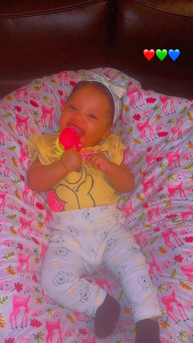 Kanyla is registered to the contest to win money with this photo: baby, baby_toddler_clothing, cheek, comfort, finger, fun, hand, human_body, mouth, orange, organ, people, person, pink, product, skin, stomach, textile, thigh, toddler