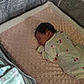 Sierra is registered to the contest to win money with this photo: newborn, baby, sleeping, onesie, cherry_pattern, blanket, pink, crib, playpen, mesh, soft_texture, infant, peaceful, indoors, warning_label, closeup, child, cute, resting, cozy