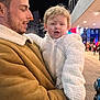 Nevaeh-Rae is registered to the contest to win money with this photo: man, child, toddler, coat, jacket, street, night, city, people, neon_lights, warm_clothing, urban, side_profile, holding, expression, curly_hair, outdoor, pedestrians, building, stroller