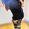 Jesse is registered to the contest to win money with this photo: woman, baby, indoor, kiss, camo_pants, slippers, wood_floor, holding, affection, portrait, person, love, family, casual_clothing, home, standing, blurred_background, side_view, toddler, affectionate
