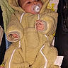 Jesse is registered to the contest to win money with this photo: baby, pacifier, onesie, bear_ears, blanket, quilt, infant, clothing, cute, sleepwear, child, person, soft, warm, indoor, resting, newborn, footwear, lying_down, cozy
