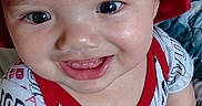 Jesse joined the competition — help win amazing prizes! arm, baby, blanket, bucket_hat, child, cute, eyes, face, hand, happy, indoor, infant, patterned_clothing, person, portrait, red_hat, shirt, smiling, texture, young_child