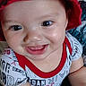 Jesse joined the competition — help win amazing prizes! baby, child, smiling, red_hat, bucket_hat, shirt, patterned_clothing, face, eyes, arm, hand, blanket, texture, indoor, person, happy, cute, portrait, infant, young_child