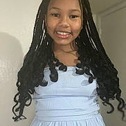 Brooklyn is registered to the contest to win money with this photo: child, girl, smile, braids, long_hair, dress, portrait, indoor, wall, happy, teeth, face, person, eyes, lips, shoulders, standing, young, fashion, lighting