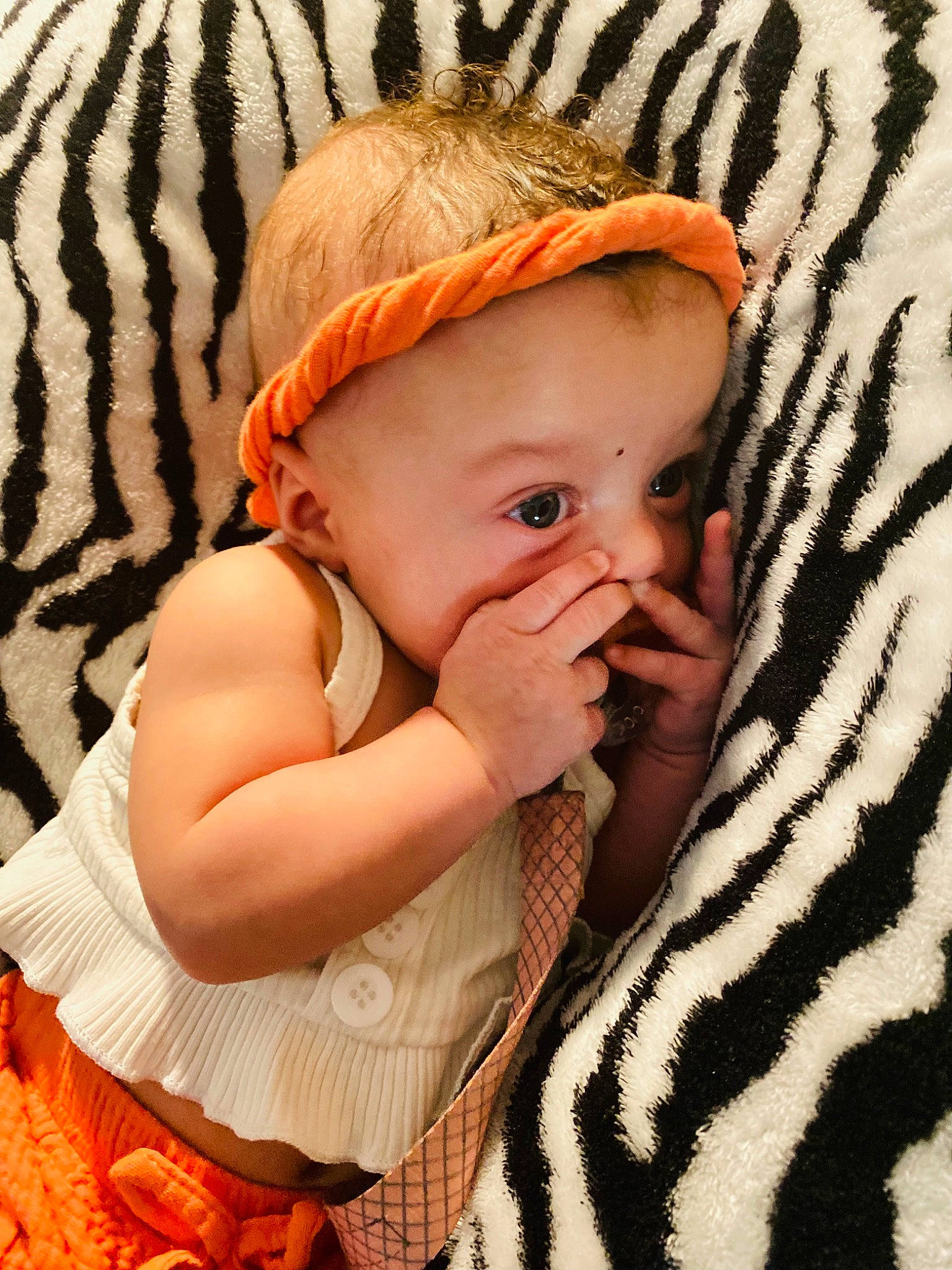 Ariyah joined the competition — help win amazing prizes! baby, baby_toddler_clothing, cap, child, comfort, fashion_accessory, fun, grass, hair_accessory, happy, iris, linens, orange, pattern, people_in_nature, person, sitting, skin, sun_hat, toddler