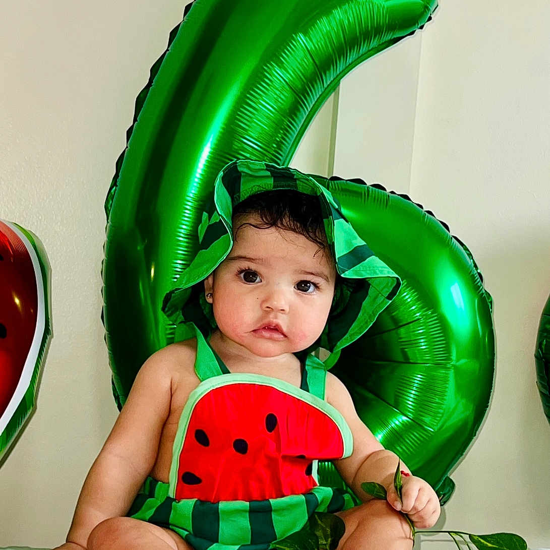 Allison joined the competition — help win amazing prizes! baby, balloon, clothing, costume, dress, face, food, fruit, furniture, green, hat, head, person, photography, plant, portrait, pottedplant, produce, summer, text