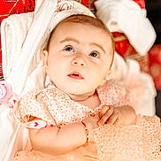 Jessica is registered to the contest to win money with this photo: baby, infant, child, face, eyes, hands, clothing, blanket, soft, cute, portrait, indoors, expression, skin, head, bracelet, pink, red, texture, sleepwear