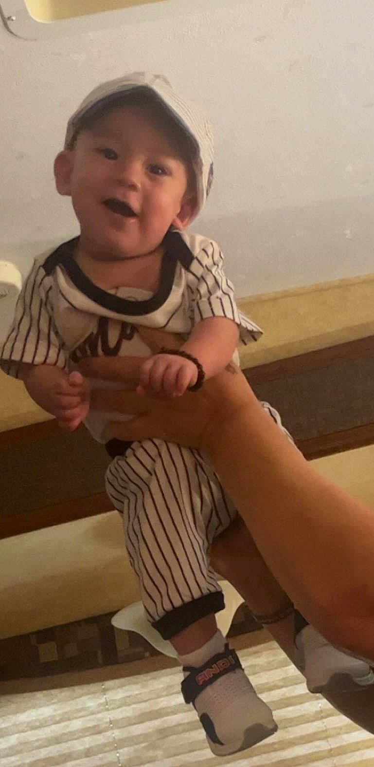 Beau is registered to the contest to win money with this photo: baby_toddler_clothing, cool, elbow, finger, flooring, fun, gesture, happy, hat, human_leg, knee, mouth, person, skin, sleeve, smile, t_shirt, thigh, thumb, toddler