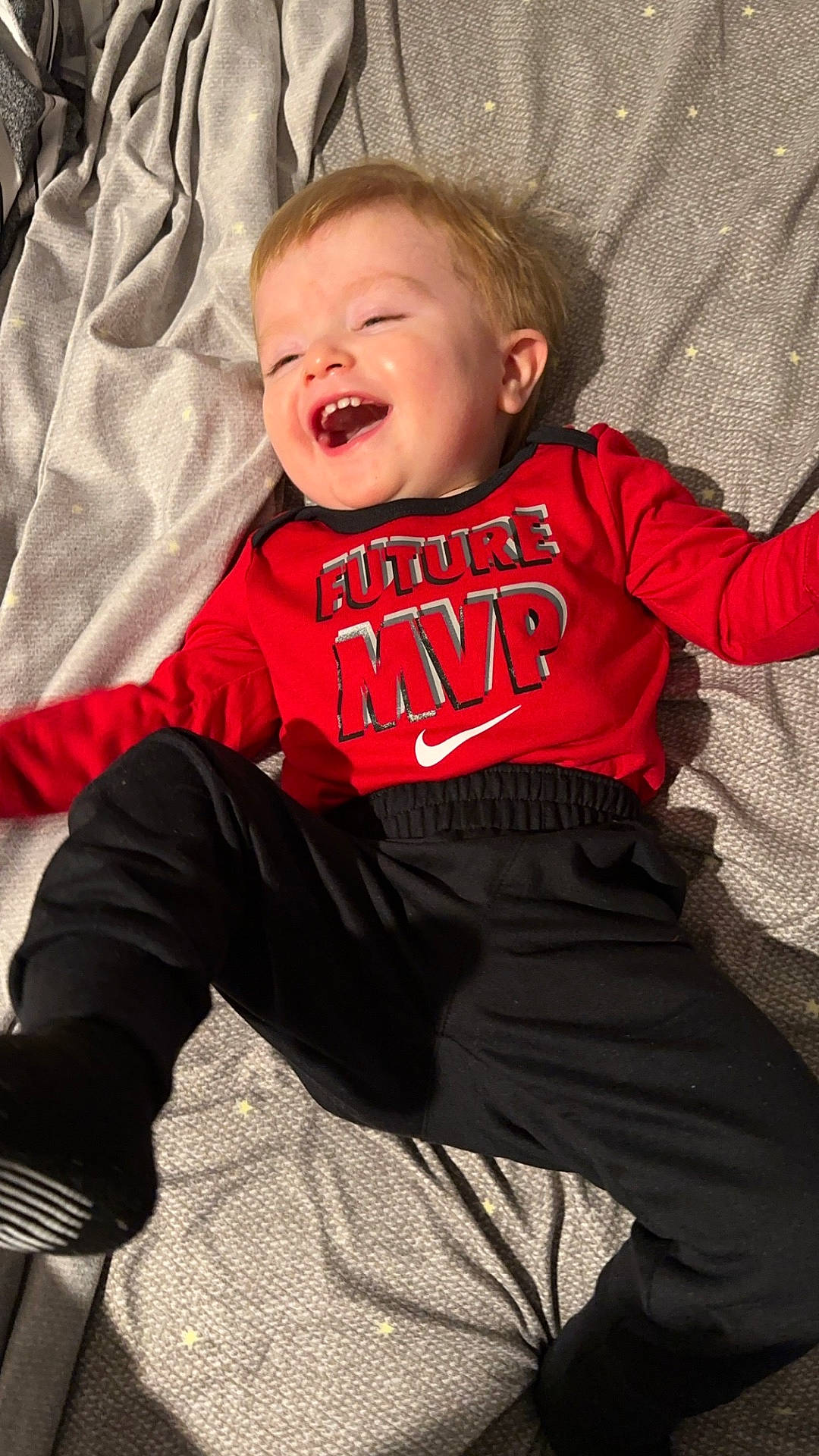 Zane is registered to the contest to win money with this photo: accessories, applique, baby, babylaughing, bed, bedroom, blonde, bodypart, clothing, coat, couch, crying, cushion, dress, face, finger, footwear, formalwear, furniture, glove