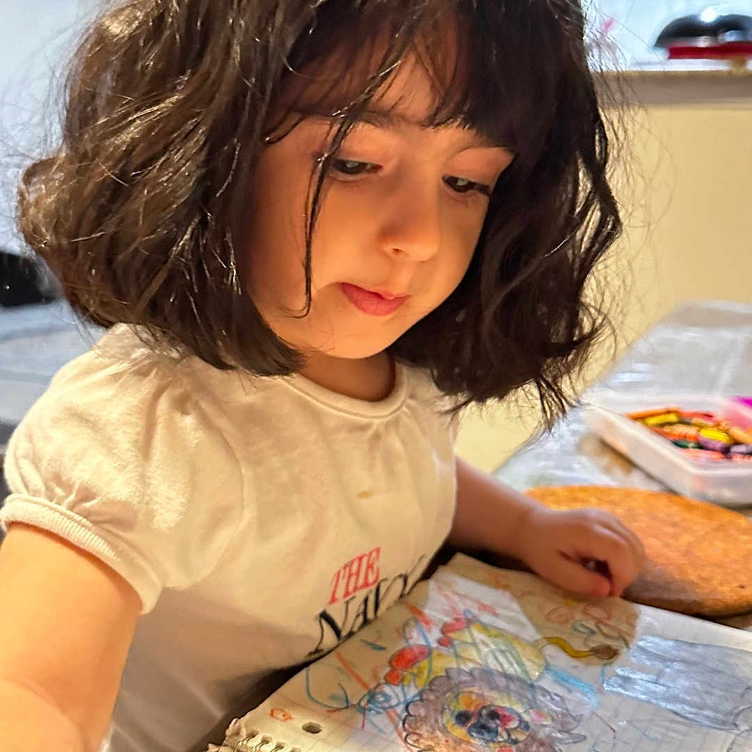 Jory joined the competition — help win amazing prizes! blackhair, bodypart, bread, child, clothing, face, female, finger, food, furniture, girl, hair, hand, head, person, photography, portrait, t_shirt, table, wig