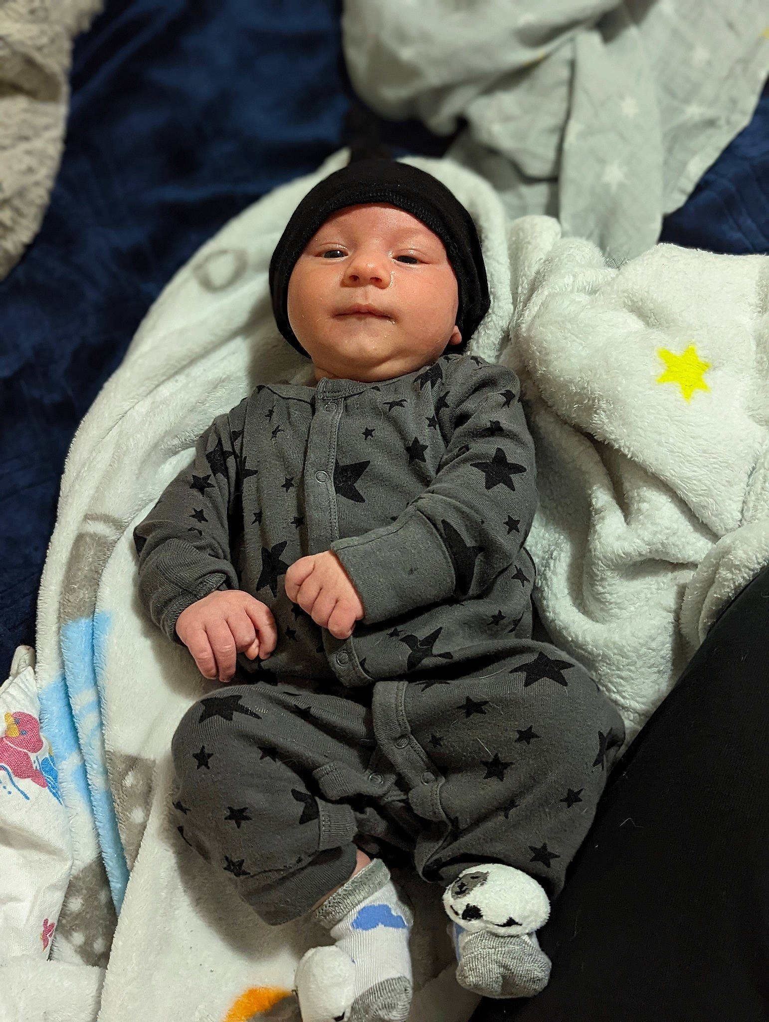 Desmond is registered to the contest to win money with this photo: baby, baby_products, baby_toddler_clothing, bottle, cheek, child, comfort, freezing, fun, grass, happy, head, headwear, hoodie, human, outerwear, person, sitting, sleeve, toddler