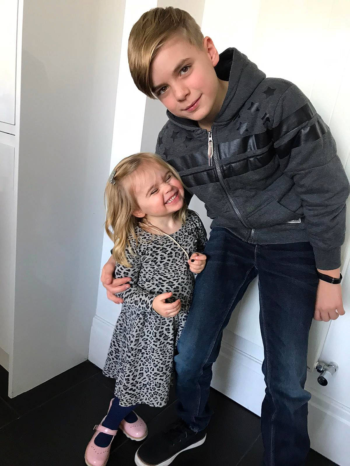 Jack is registered to the contest to win money with this photo: blond, child, daughter, fashion_design, footwear, hairstyle, joint, joy, leg, outerwear, person, photography, shoe, sitting, standing, toddler, trunk