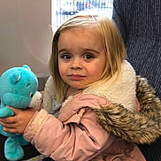 Daisy joined the competition — help win amazing prizes! casual, child, clothing, curly_hair, cute, expression, face, fur_hood, girl, holding, indoor, person, pink_jacket, plush_toy, portrait, seat, teddy_bear, toy, window, young