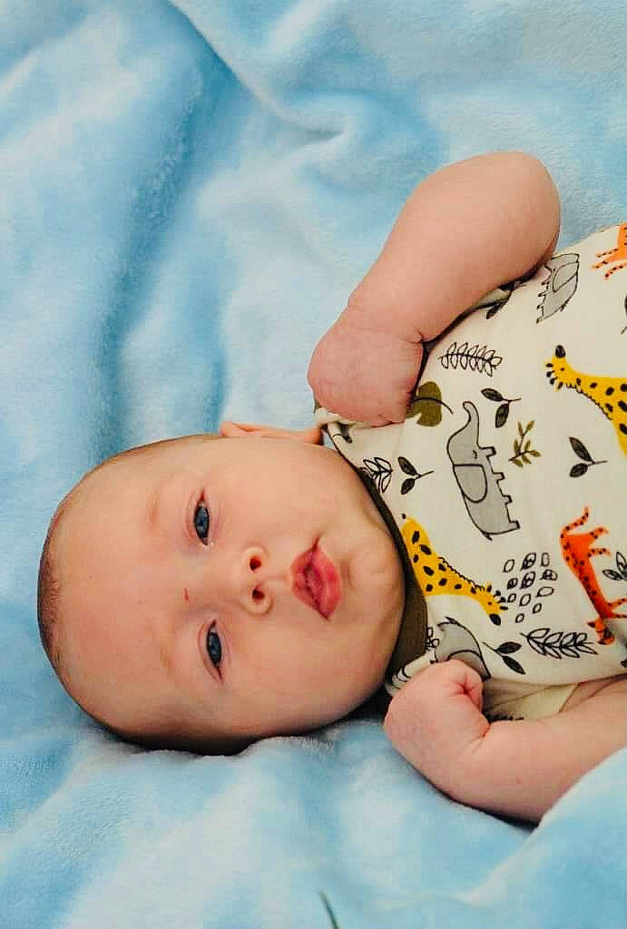 George is registered to the contest to win money with this photo: baby, baby_sleeping, baby_toddler_clothing, cheek, child, comfort, eye, finger, gesture, hand, happy, iris, linens, mouth, nose, pattern, person, skin, sleeve, thumb