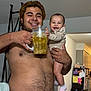 Aryanna is registered to the contest to win money with this photo: man, baby, smile, shirtless, mug, beverage, indoor, kitchen, cabinet, refrigerator, notes, clothing, socks, person, happy, holding, home, family, child, casual