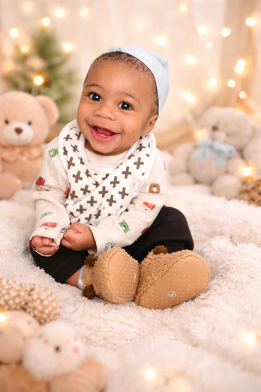 Eziah is registered to the contest to win money with this photo: baby, smiling, child, teddy_bear, soft_toys, blanket, cute, indoors, warm_lighting, happy, portrait, sitting, hat, cozy, infant, playful, clothing, footwear, decor, holiday