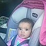 Aubrey is registered to the contest to win money with this photo: baby, car_seat, child, seat_belt, infant, car_interior, pink, gray, clothing, person, face, sitting, young_child, portrait, seat, straps, looking, indoors, eyes, head