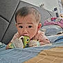 baby, bed, bedroom, blanket, chewing, child, comfort, curious, cute, face, head, indoor, infant, lying_down, mittens, pillow, sleepwear, small_person, soft_toys, toy