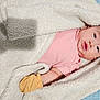 baby, blanket, pink_shirt, yellow_mitten, infant, cozy, soft_texture, lying_down, face, skin, portrait, cute, newborn, indoors, warm, child, sleepwear, bed, comfort, resting