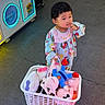 Celine joined the competition — help win amazing prizes! arcade, basket, carpet, child, colorful_clothing, cute, dress, indoor, pink_toy, play_area, plush_toys, portrait, prize_machine, shopping, smiling, standing, stuffed_animals, superhero_toy, toddler, toy_basket