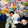 Celine is registered to the contest to win money with this photo: black_couch, child, colorful, cuddling, cute, face, indoors, large_plush, pajamas, photography, playroom, plush_toys, portrait, shoes, sitting, smiling, stuffed_animals, toddler, toy_collection, toy_store