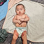 baby, infant, diaper, towel, blanket, cloth, skin, bare_chest, lying_down, indoors, cute, child, person, soft_texture, pink, white, gray, hand, foot, expression