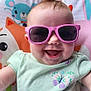 animal_print, baby, child, clothing, colorful, cute, face, fashion, funny_hair, happy, indoor, infant, joyful, mohawk, playful, portrait, seat, smile, sunglasses, toddler