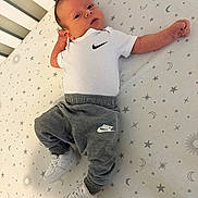 August is registered to the contest to win money with this photo: animal, baby, bird, clothing, crib, face, footwear, furniture, happy, head, infantbed, jeans, pants, person, photography, portrait, shoe, sitting, sleeve, yawning