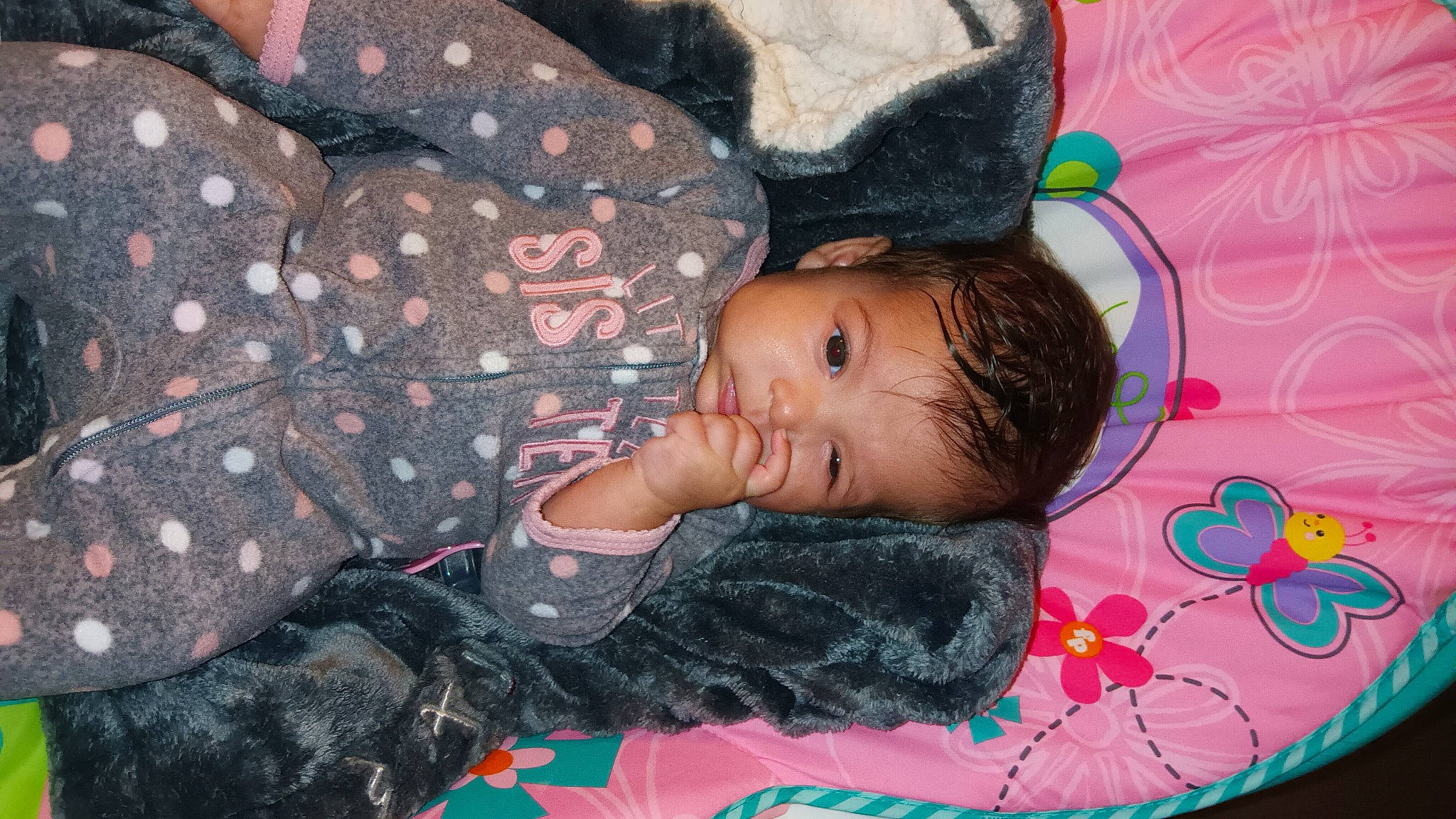 Amora is registered to the contest to win money with this photo: baby, baby_toddler_clothing, beauty, cheek, child, comfort, face, fun, happy, linens, magenta, pattern, person, pink, product, purple, room, skin, textile, toddler