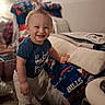 Paxtyn joined the competition — help win amazing prizes! bed, blanket, blue_shirt, blurred_background, carpet, casual_clothing, child, cozy, face, furniture, happy, home, indoor, leaning, mohawk, pants, person, smiling, standing, toddler