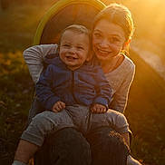 Paxtyn is registered to the contest to win money with this photo: baby, casual, chair, child, clothing, face, family, golden_hour, grass, happy, nature, outdoor, person, portrait, sitting, smiling, sunlight, toddler, warm_light, young_child
