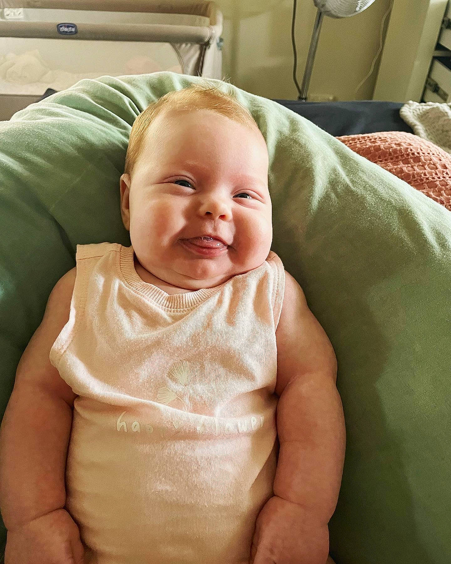 Stevie is registered to the contest to win money with this photo: baby, baby_toddler_clothing, cheek, child, chin, comfort, eye, facial_expression, happy, head, linens, mouth, person, room, sitting, skin, sleeve, smile, textile, thumb