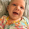 Cali joined the competition — help win amazing prizes! baby, smile, face, infant, child, colorful_clothing, floral_pattern, pillow, happy, cute, portrait, indoors, closeup, young_child, skin, head, eyes, mouth, newborn, person