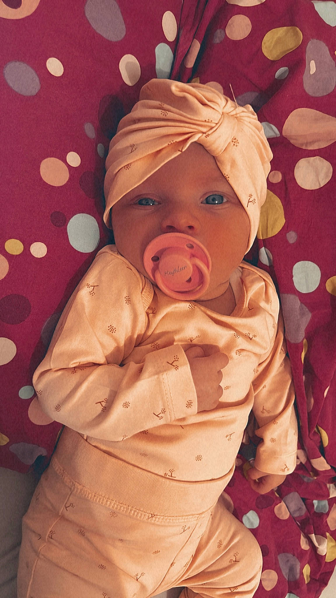 Keythleen participe au concours pour gagner de l'argent avec cette photo : baby, baby_toddler_clothing, cheek, child, comfort, eye, face, head, headwear, human_body, jacket, linens, mouth, nose, orange, peach, person, pink, skin, sleeve