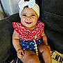 Lylah joined the competition — help win amazing prizes! baby, smiling, headband, bow, red_clothing, blue_clothing, stars_pattern, sitting, armchair, blanket, happy, cute, indoor, child, person, infant, portrait, chubby_arms, cheerful, home