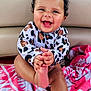 baby, child, smiling, curly_hair, onesie, foot, hands, towel, pink, white, sitting, happy, cute, infant, skin, face, indoors, playing, joyful, expression