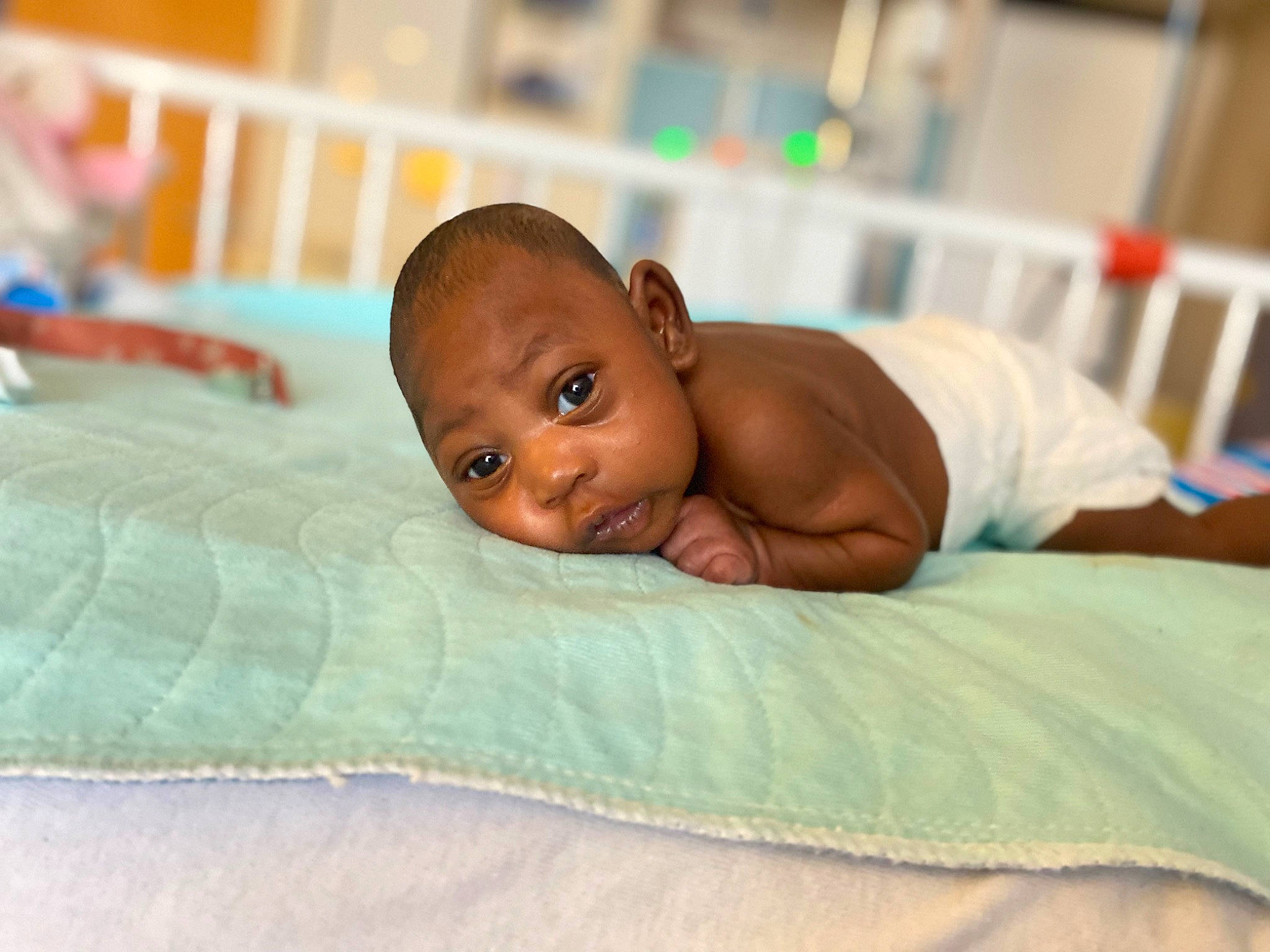 Maloni is registered to the contest to win money with this photo: abdomen, baby, bed_sheet, bedding, bedtime, blanket, child, comfort, event, flooring, grass, happy, leisure, linens, person, room, toddler, wood