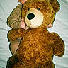 baby, teddy_bear, plush_toy, child, cute, soft_toy, infant, hugging, lying_down, white_background, indoors, cozy, playful, smiling, portrait, bed, comfort, warm, adorable, childhood