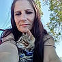 woman, cat, kitten, outdoor, nature, trees, blue_sky, collar, bell, long_hair, portrait, sunlight, pet, animal, casual, relaxing, closeup, looking_away, happy, sitting