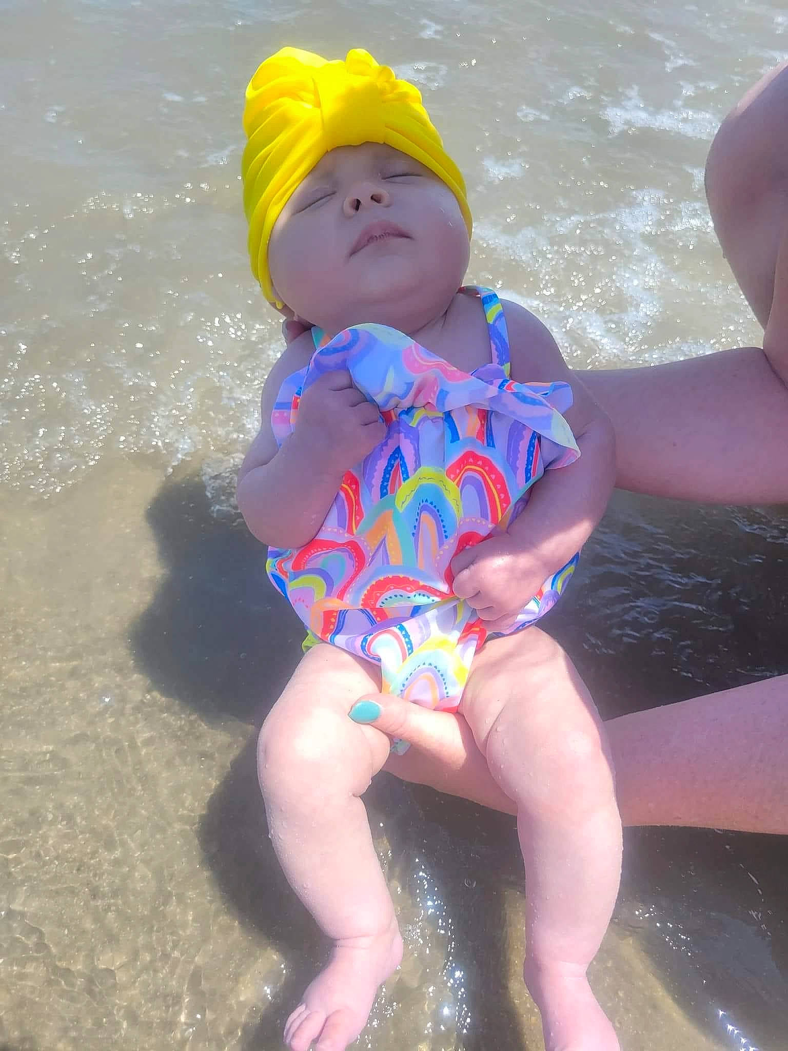 Charli Rose joined the competition — help win amazing prizes! baby_toddler_clothing, barefoot, beach, child, electric_blue, foot, fun, happy, headwear, human_leg, leg, leisure, maillot, one_piece_swimsuit, person, personal_protective_equipment, pink, sitting, swimwear, thigh