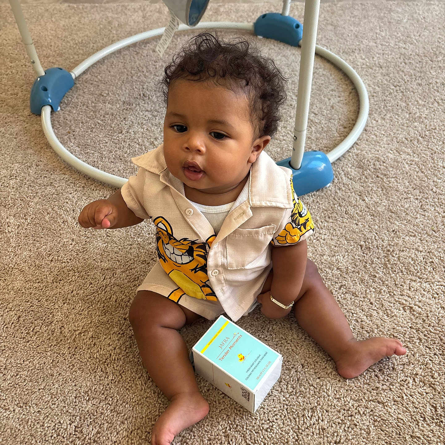 Axston joined the competition — help win amazing prizes! activity_center, baby, beige, blue, box, carpet, casual, child, clothing, curly_hair, cute, floor, indoor, infant, person, playful, sitting, smiling, toy, young