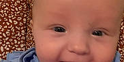 Serenity joined the competition — help win amazing prizes! baby, smiling, blue_shirt, embroidery, closeup, face, person, child, happy, infant, human, sitting, apparel, patterned_clothing, skin, tongue, eyes, mouth, cheeks, holding