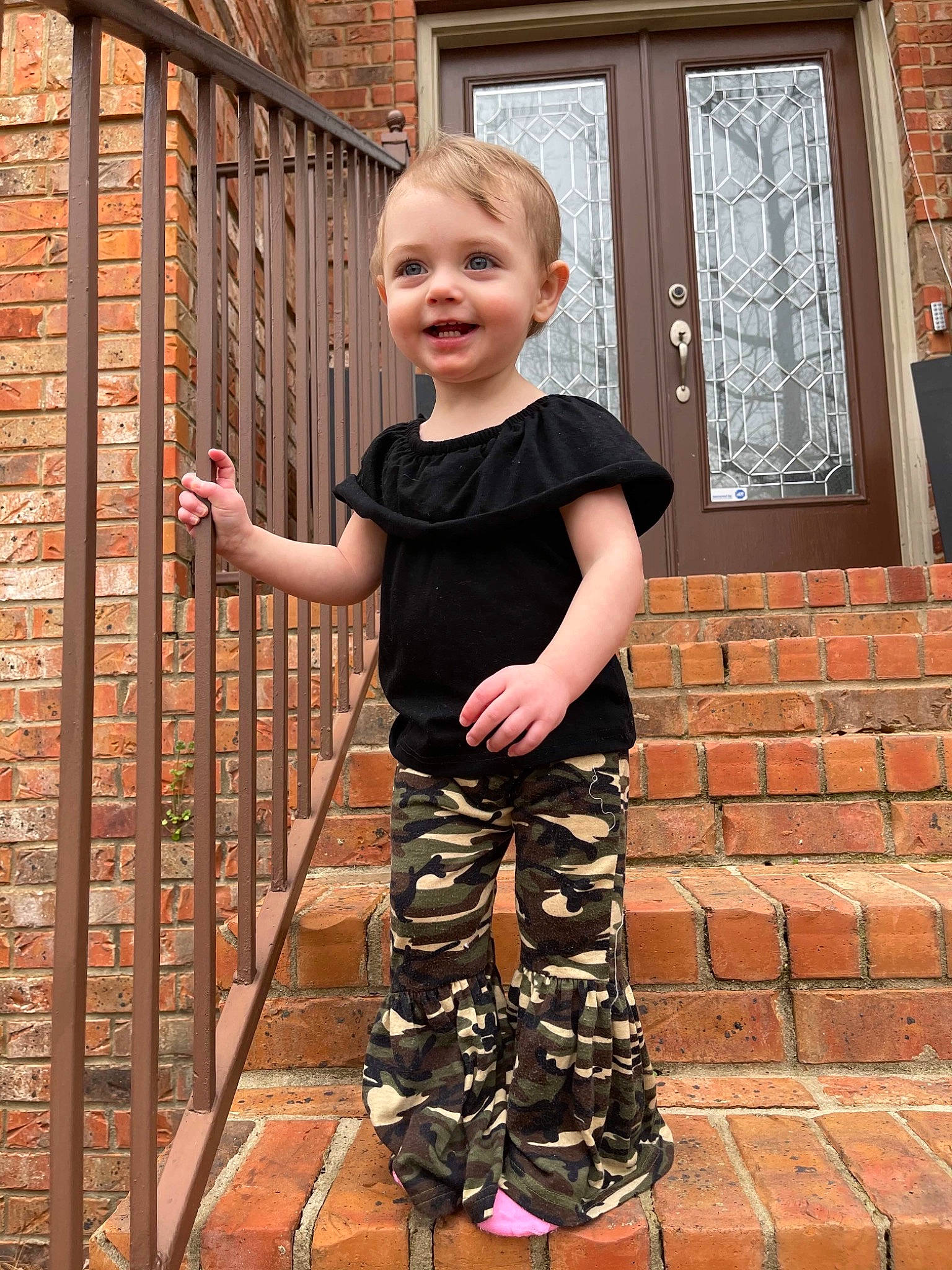 Maddison joined the competition — help win amazing prizes! baby, baby_toddler_clothing, child, fence, happy, human_leg, joint, joy, leg, orange, pattern, people_in_nature, person, sleeve, smile, standing, street_fashion, t_shirt, toddler, waist